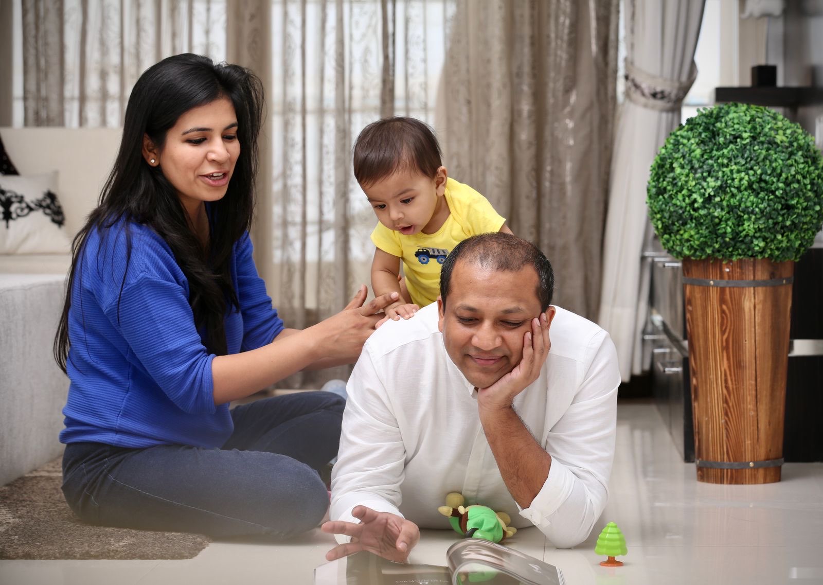 Parents guiding a child through a structured play activity at home