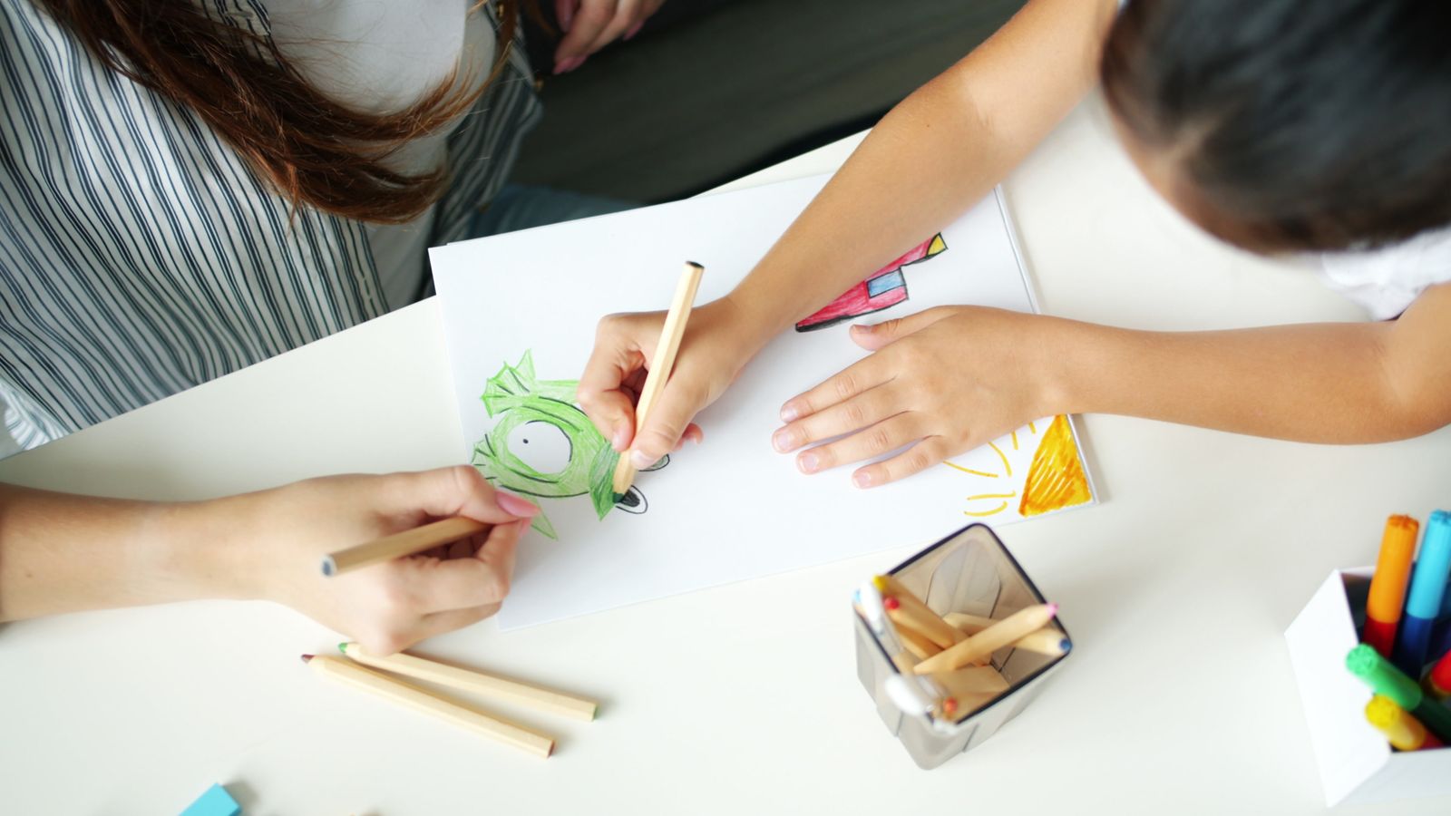 Parent and child drawing together as part of a home therapy activity
