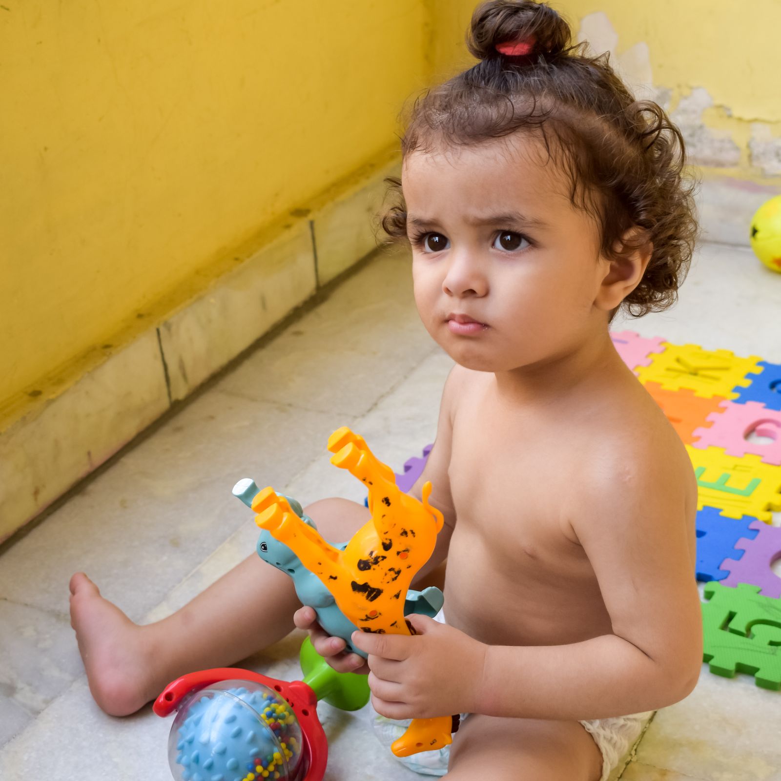 Child engaging in sensory and motor-skill play